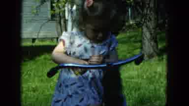 Hicksville New York (1954): Young Female Toddler Fixes Bike Handle With