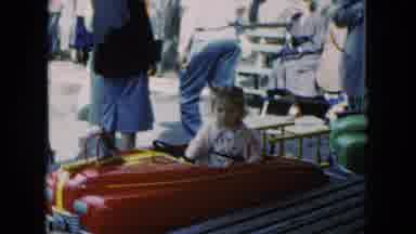 Hicksville New York (1954): Little Child Gets Ready To Ride On A Toy In An