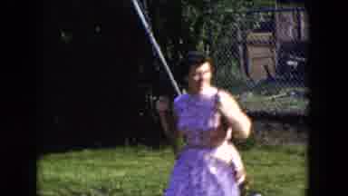 Hicksville New York (1954): Mother And Child Play Outside On The On Swings On A