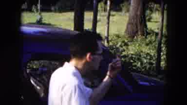 Hicksville New York (1954): Man With Glasses Stands By Car & Points Man Walks Down