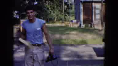 Hicksville New York (1954): Clip Of A Man Walking Up With A Large Book And Another
