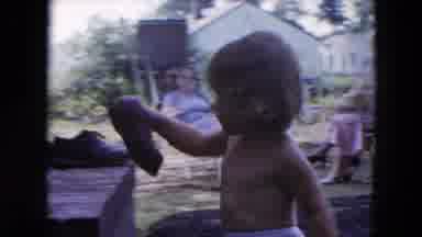 Hicksville New York (1954): The Child Cleans Its Sandals And The Two Men Work