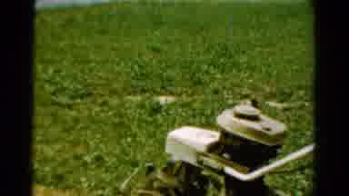 California USA (1954): Two Young Boys Using A Gas Tilling Machine To Till A Yard