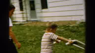 California USA (1954): A Little Boy Crop The Grass In The Garden Is The Good Hobby