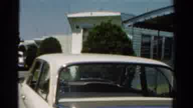 California USA (1954): Close-Up Of A Parked White Classic Car By A Restaurant