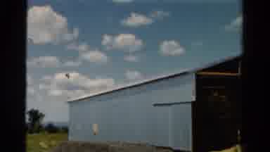 California USA (1954): Clouds In The Sky Above A Blue Barn House