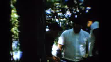 California USA (1954): Three Men Gathered Outdoors Surrounded By Trees In The
