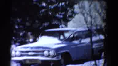 Toledo Ohio USA (1954): Blue Car Stopped Sitting Behind Barren Trees In The Winter