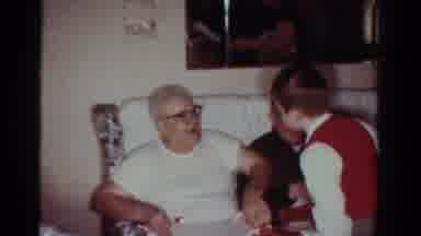 Toledo Ohio USA (1954): Boy Wearing Red Sweater Talks To Man Wearing White Shirt