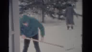 Toledo Ohio USA (1954): A Lady Is Walking In The Snow And The Man Is Removing The