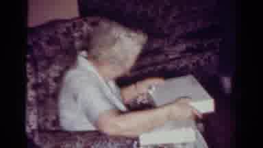Toledo Ohio USA (1954): Woman Opens Gift Box Sitting In The Living Room Of Her