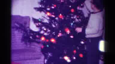 Toledo Ohio USA (1954): Man Stands In Front Of A Christmas Tree With Lights On In
