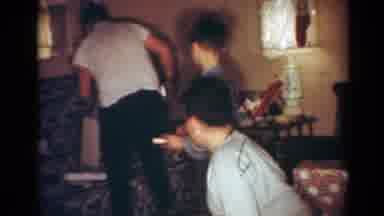 Toledo Ohio USA (1954): Three Boys Excitedly Opening Up Christmas Presents And