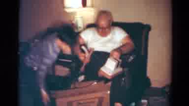 Toledo Ohio USA (1954): Man Opens Christmas Presents Accompanied By Boy In Great