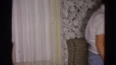 Toledo Ohio USA (1954): Man Wearing White Shirt Walks Past Window With White