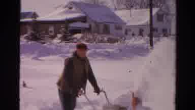 Toledo Ohio USA (1954): Man Using Snow Blower On Street Near House While Other Man