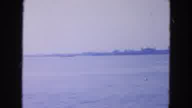 New York City (1954): View Of Ellis Island And New York City From Boat On A Cloudy