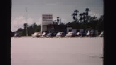 Dade County Florida (1955): Car Drives By Business With Florida Welcomes You Sign