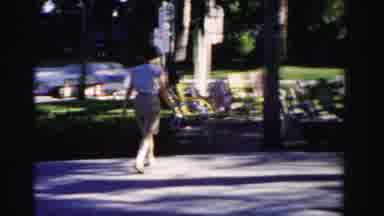 Dade County Florida (1955): Woman Wearing A Blouse And Shorts Walks Through Park