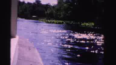 Dade County Florida (1955): A Boat Moving On The Water With Sunshine On It