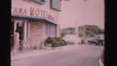 Dade County Florida (1955): A Woman Walks Along The Sidewalk Of A Motel Wearing