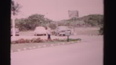 Dade County Florida (1955): Man Walks Towards Motel Building On Busy Street On A