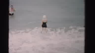 Dade County Florida (1955): Couple Wearing Black Swimwear Wade In Seawaves At