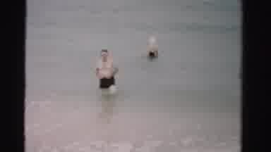 Dade County Florida (1955): Man Walking And Women Wading In Ocean At The Shore