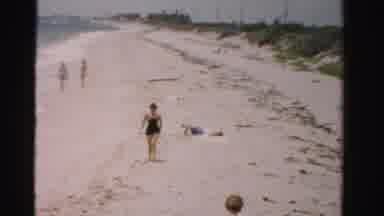 Dade County Florida (1955): Girl Walking And Playing On The Beach While A Plane Is