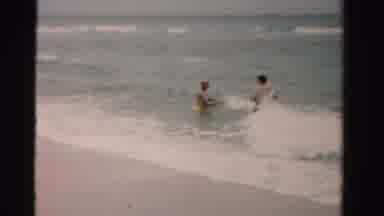 Dade County Florida (1955): People On A Beach Sunbathing On Towels A Playing In