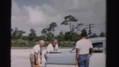 Dade County Florida (1955): A Car Is Loaded Up With Some Bags Of Fruit While Other