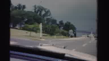Dade County Florida (1955): Driving Onto A Bridge That Spans Across A Large Body