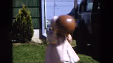 Hicksville New York (1955): Girl Wearing Pink Dress Throws Brown Ball On A Bright