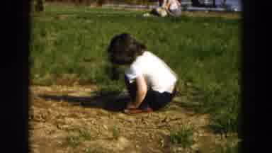 Hicksville New York (1955): Little Girl Plays With A Small Shovel On The Ground In