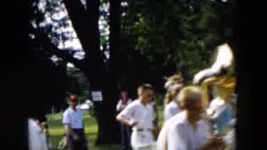 Hicksville New York (1955): Marching Band Marching In A Parade Next To A Green