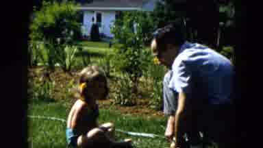 Hicksville New York (1955): Little Girl Turning On Water Hose Outside With Her Dad