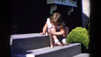 Hicksville New York (1955): Girl Plays With Gold Slinky Toy On Steps On A Sunny