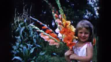 Hicksville New York (1955): A Child Holds Flowers In Its Hand And Turns It Back