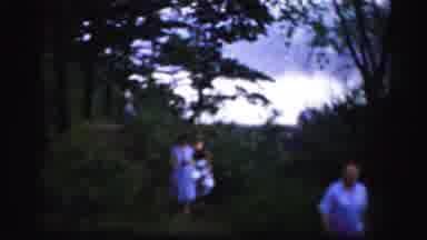 Albany New York (1955): Three People Walking On A Grassy Path On A Clear Day