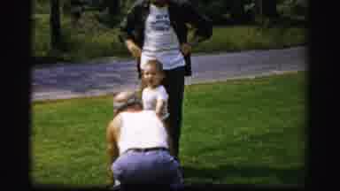 Albany New York (1955): An Old Man Kneeling Down And Playing With A Kid While