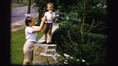 Albany New York (1955): A Woman Helping Her Son Stand On A Brick Pillar