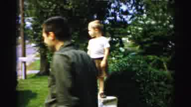 Albany New York (1955): People Wearing Yellow Rain Wear Walk Through Empty Park On