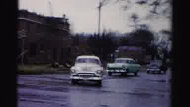 Albany New York (1955): Cars Turning A Corner Of A Brick Building And A Flood