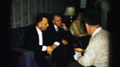 Albany New York (1955): People In Suits Talking With Each Other And Sharing