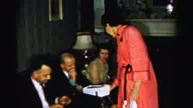 Albany New York (1955): Woman Hands Out What Appears To Be Chocolates To The Two