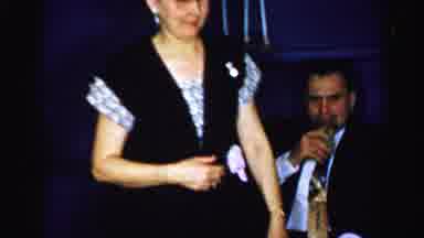 Albany New York (1955): Older Lady With Glasses On Walks Past Two Men Drinking And