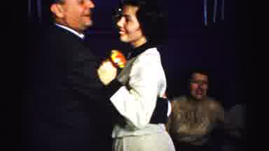 Albany New York (1955): A Happy Couple Dance Together While The Woman Holds A
