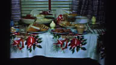 Albany New York (1955): Woman Wearing Blue Dress Adjusts Food Laden Holiday Table