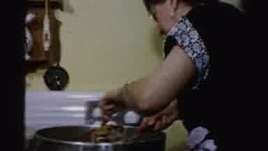 Albany New York (1955): Woman Standing Over A Pan With A Fork And Knife Cutting