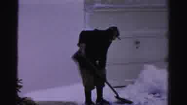 Albany New York (1955): Person Wearing Black Coat Shovels Snow From Garage Door On